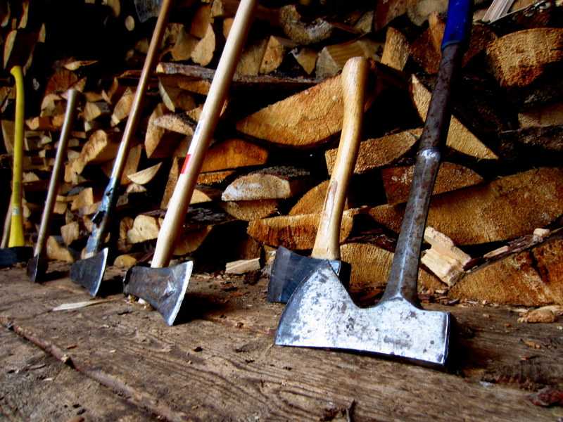 Chicago-bad-axe Multiple axes and wood stand on the ground in Chicago's Bad Axe